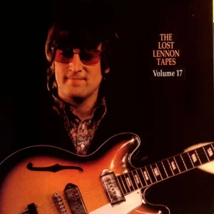A man holding an electric guitar in front of him.