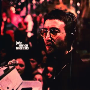 A man with headphones on and some other people in the background
