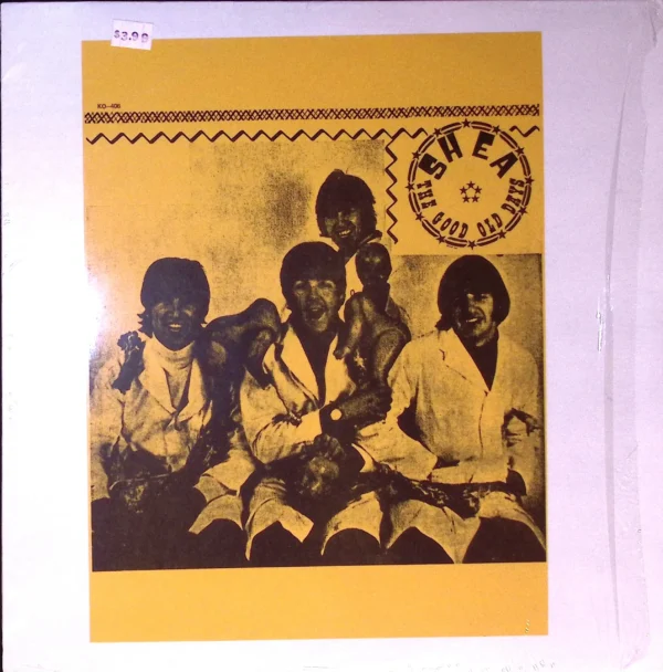 A group of people sitting on top of a yellow wall.