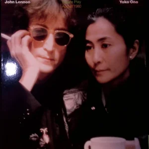 A woman and man with sunglasses on one side of their face.