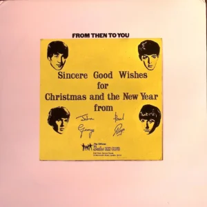 A yellow sign with four beatles on it