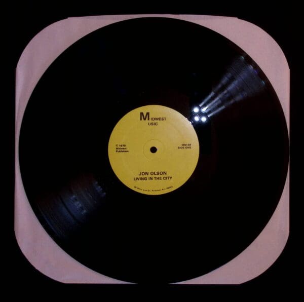 A black and yellow record is in the middle of a picture.