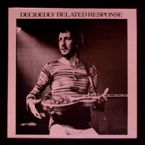 Here's an alt tag for the image: Man playing guitar on album cover.