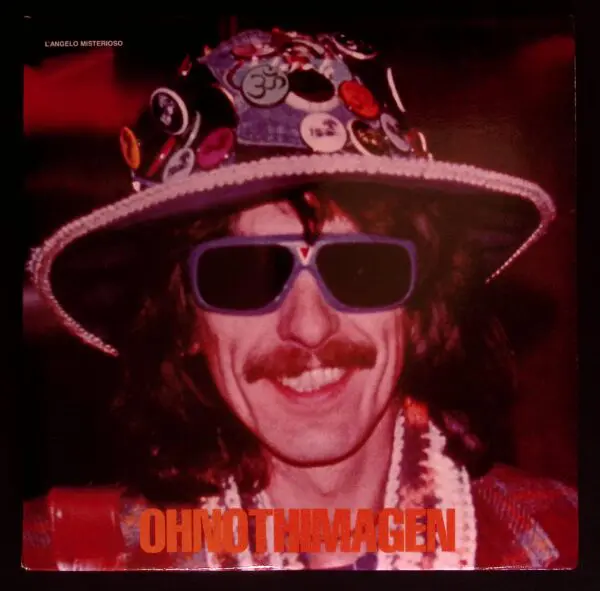 A man with long hair and sunglasses wearing a hat.