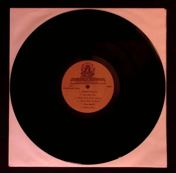 A black record with some red labels on it