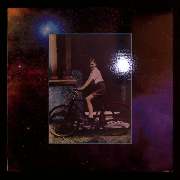 Boy on bicycle, cosmic background.