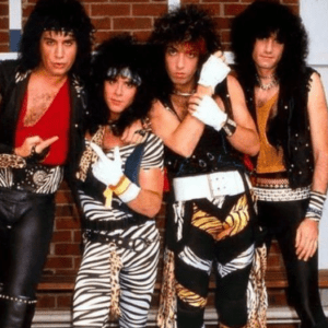 Rock band in colorful 80s outfits.