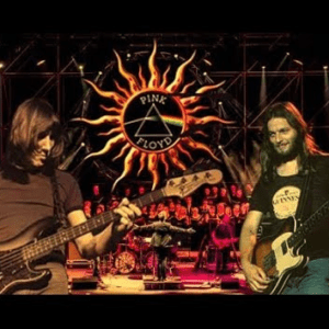 Rock band performing on stage with guitars.