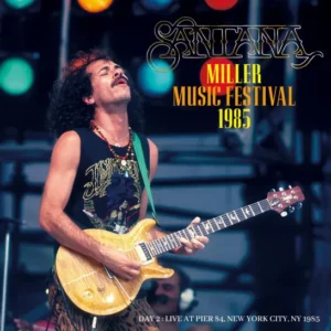 Carlos Santana passionately playing guitar at the 1983 Miller Music Festival.