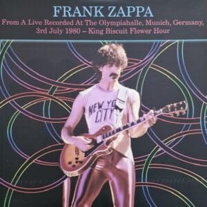 Frank Zappa performing live on stage with guitar and colorful light trails.